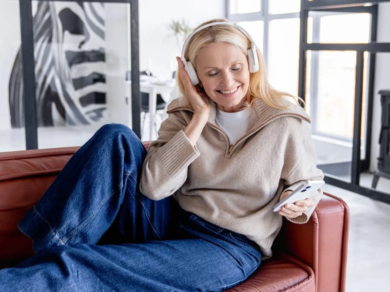 Person controlling home audio system from smartphone app
